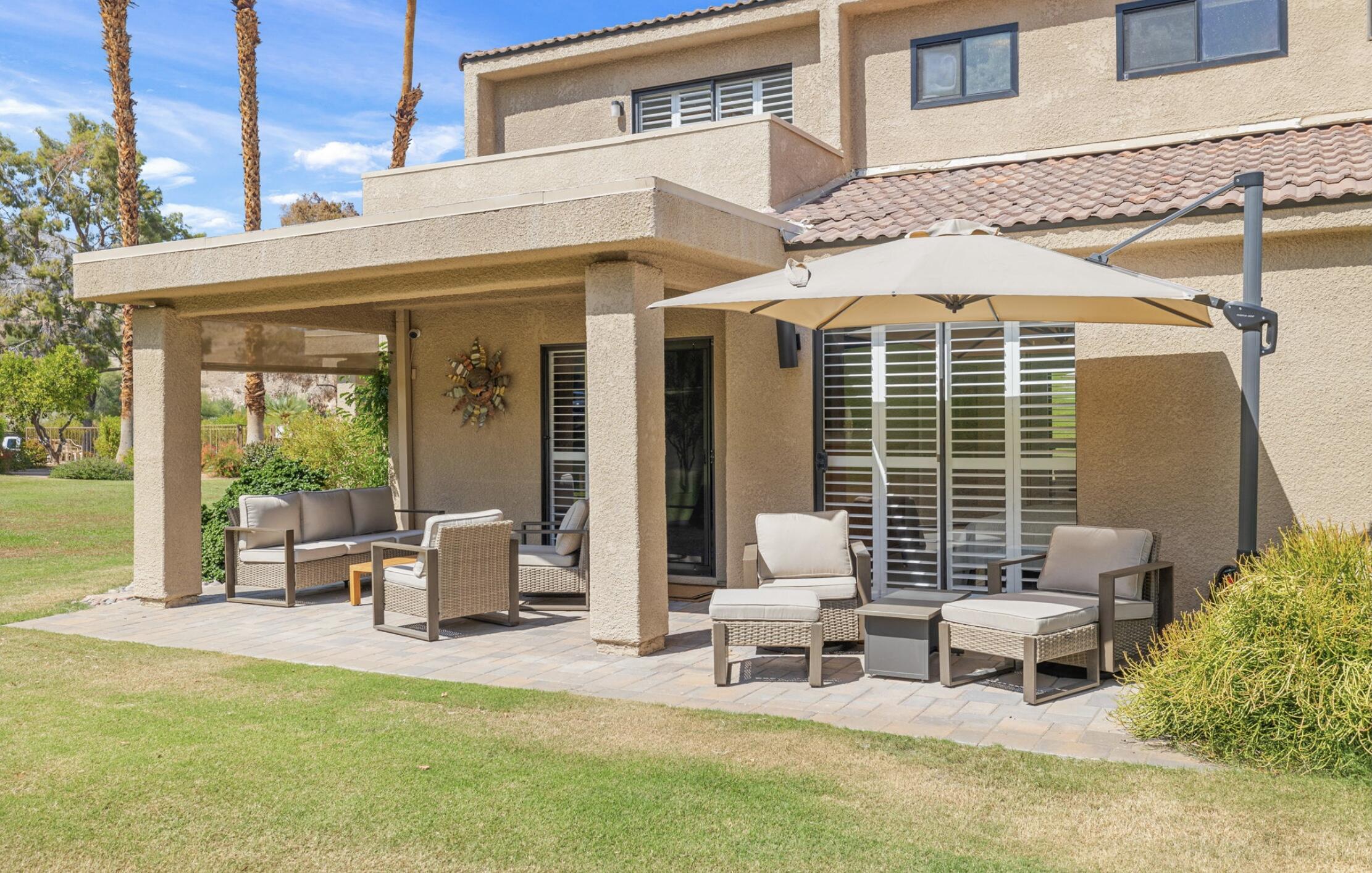 a view of a patio with table and chairs and potted plants