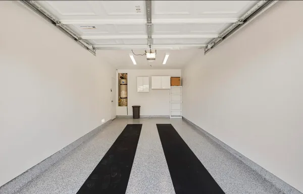 a view of a hallway with wooden floor and a chandelier
