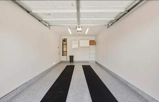 a view of a hallway with wooden floor and a chandelier