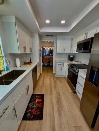 a kitchen with a sink a stove and cabinets