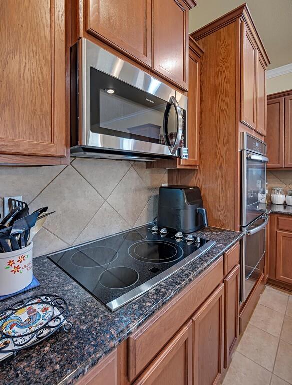 9836 Shallow Creek Drive Waco, TX 76708 - Photo 12 of 32 a kitchen with stainless steel appliances granite countertop a sink stove and microwave