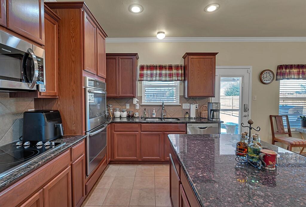 9836 Shallow Creek Drive Waco, TX 76708 - Photo 13 of 32 a kitchen with stainless steel appliances granite countertop a stove sink and cabinets