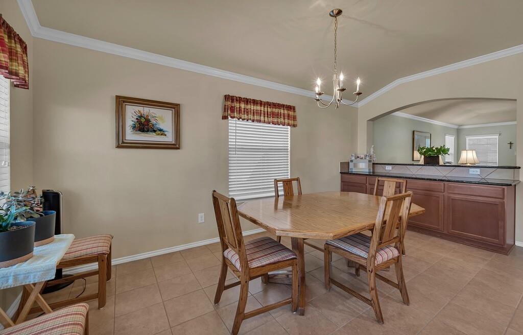 9836 Shallow Creek Drive Waco, TX 76708 - Photo 14 of 32 a view of a dining room with furniture and a chandelier