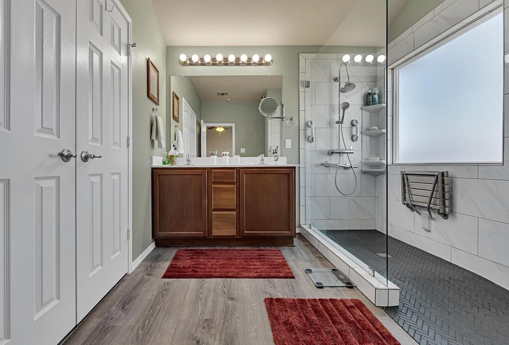 9836 Shallow Creek Drive Waco, TX 76708 - Photo 20 of 32 a bathroom with a glass shower door and a sink