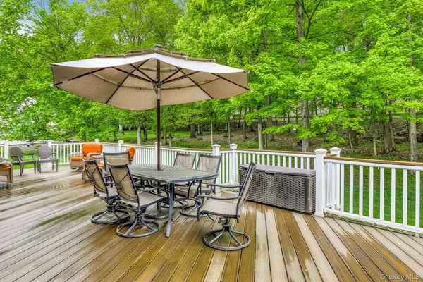 a view of balcony with outdoor seating and trees