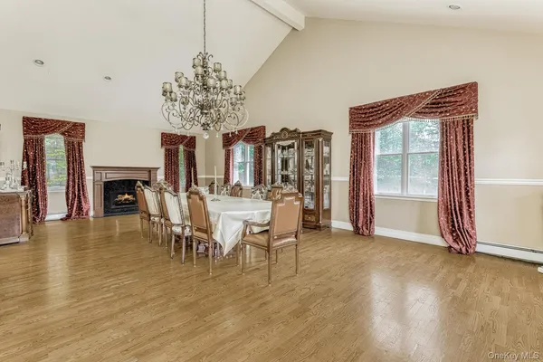a view of a dining room with furniture and chandelier