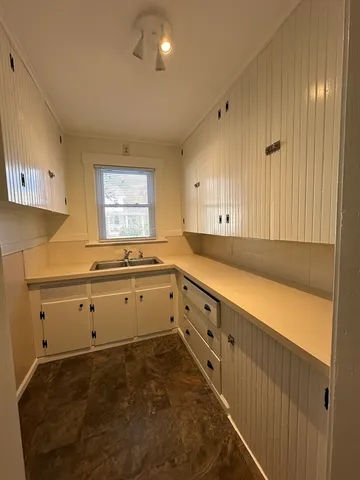 a bathroom with a toilet sink and shower
