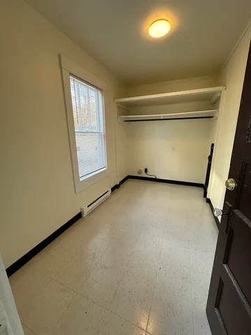 a kitchen with stainless steel appliances kitchen island granite countertop a refrigerator a stove a sink a dining table and chairs with wooden floor