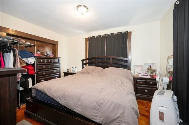 a living room with a bed furniture and a window