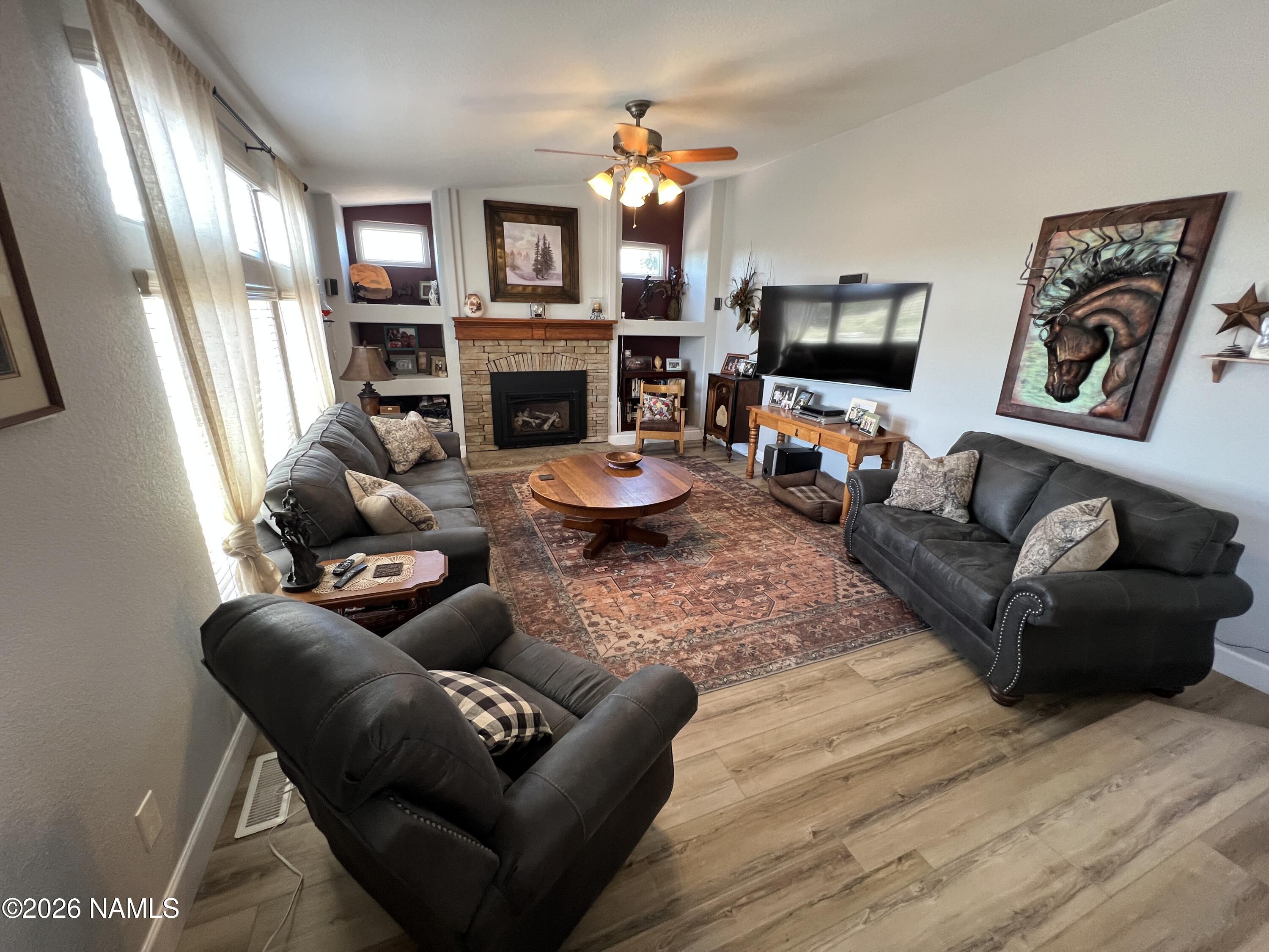 8348 Red Butte Road Williams, AZ 86046 - Photo 46 of 89 a living room with furniture a fireplace and a flat screen tv