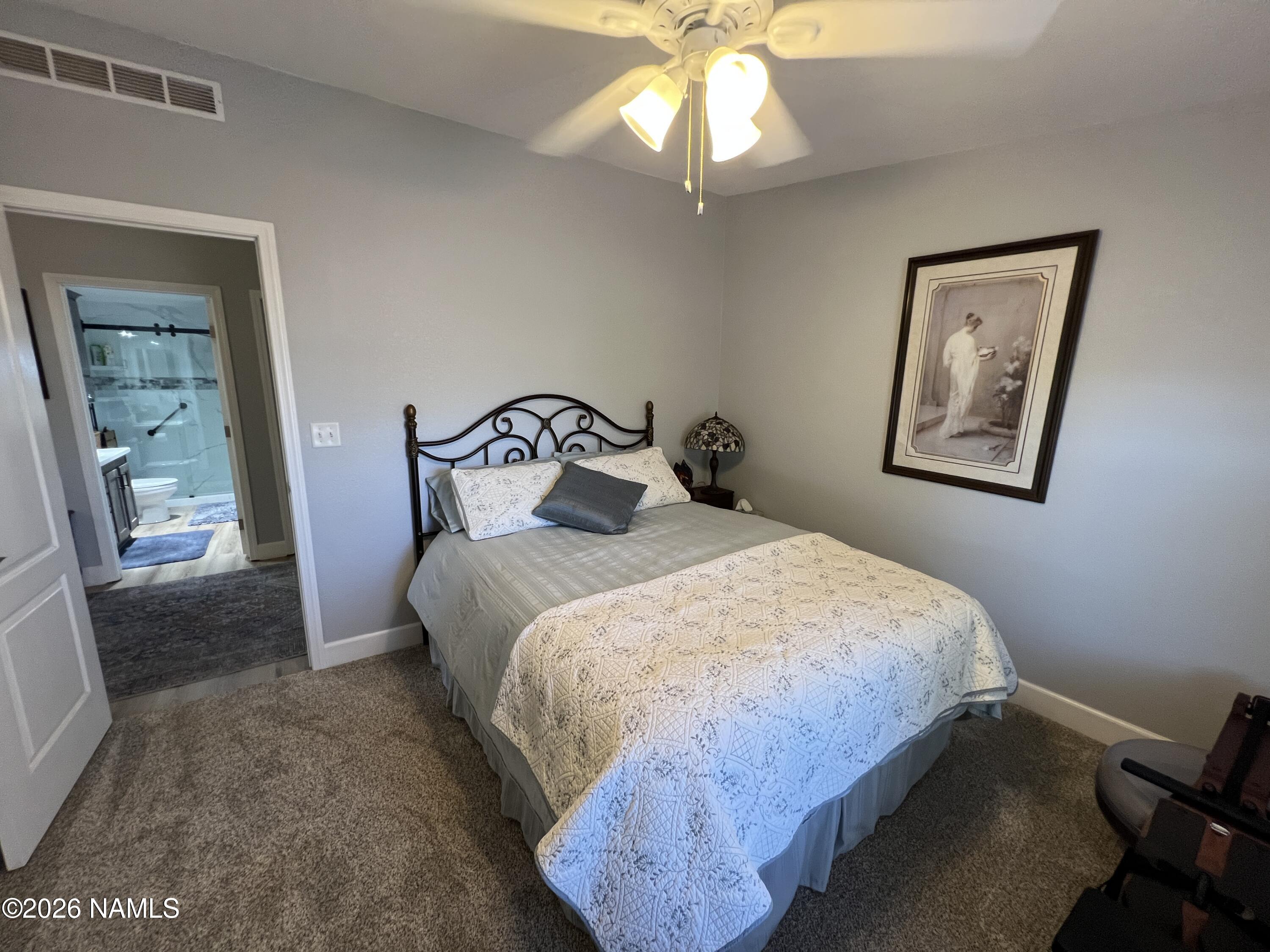 8348 Red Butte Road Williams, AZ 86046 - Photo 49 of 89 a bedroom with a bed and a painting on the wall