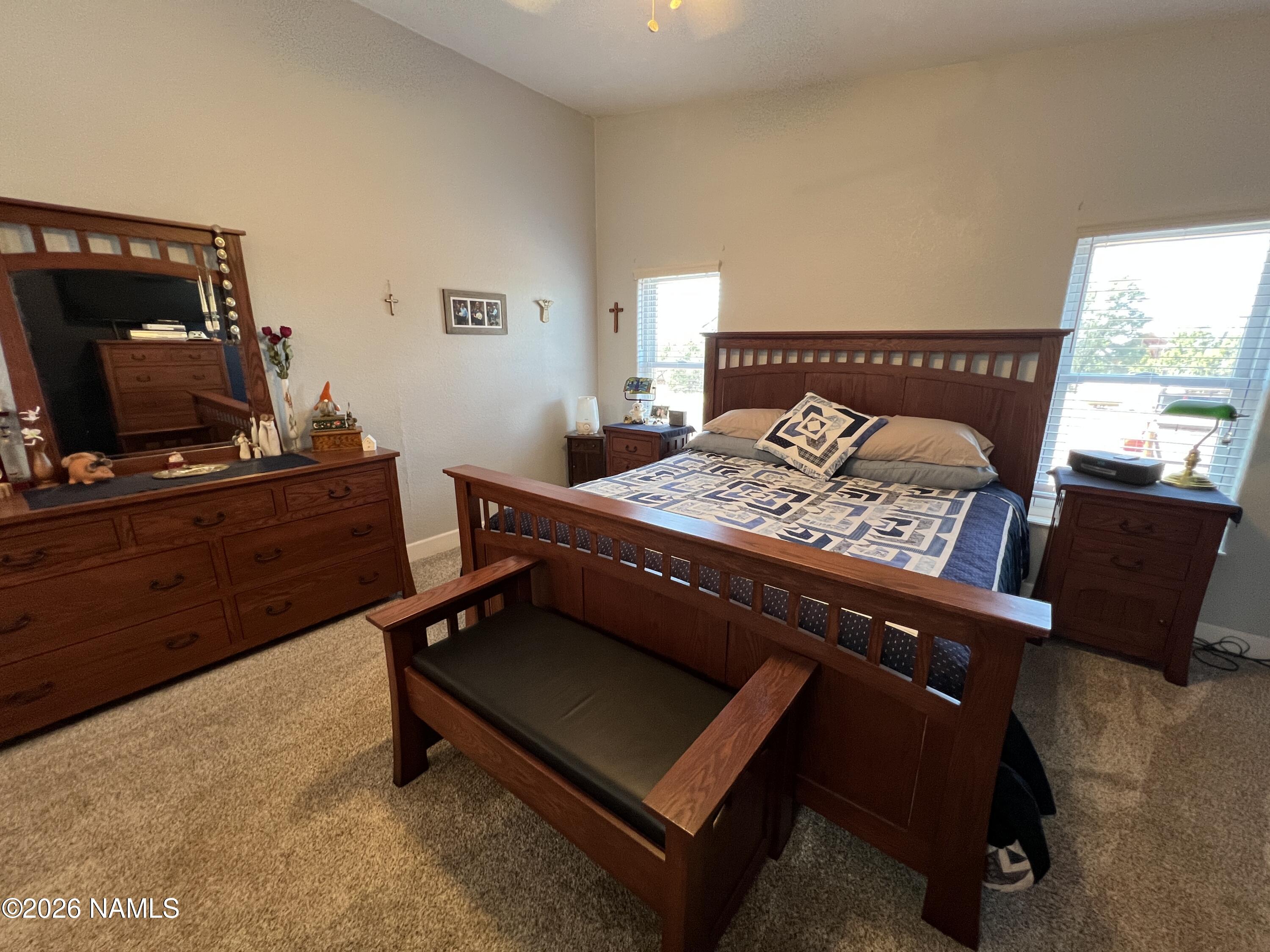 8348 Red Butte Road Williams, AZ 86046 - Photo 63 of 89 a bed sitting in a bedroom next to a window with tv