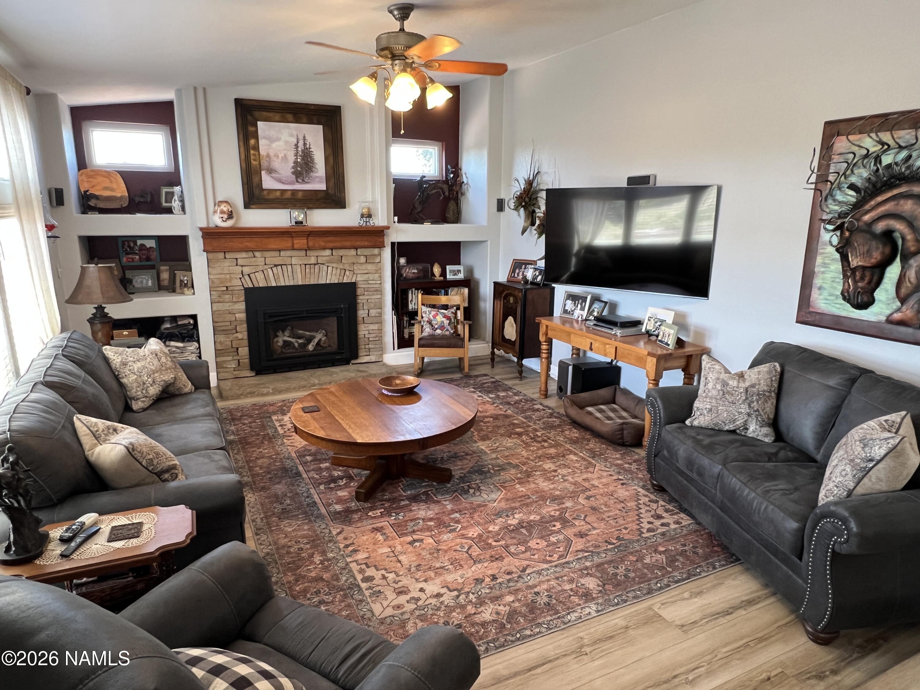 8348 Red Butte Road Williams, AZ 86046 - Photo 71 of 89 a living room with furniture a flat screen tv and a fireplace