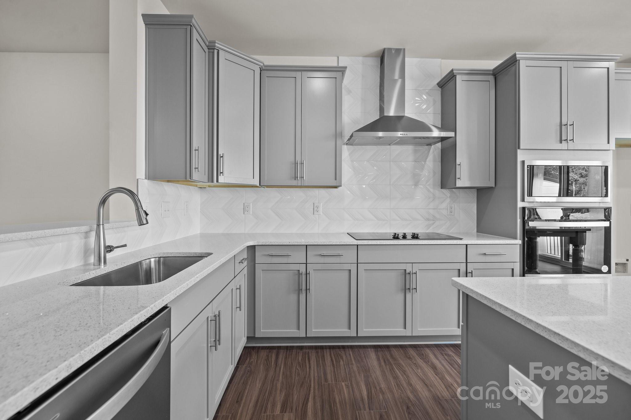 657 District Court Fort Mill, SC 29708 - Photo 12 of 32 a kitchen with stainless steel appliances granite countertop a sink stove and cabinets