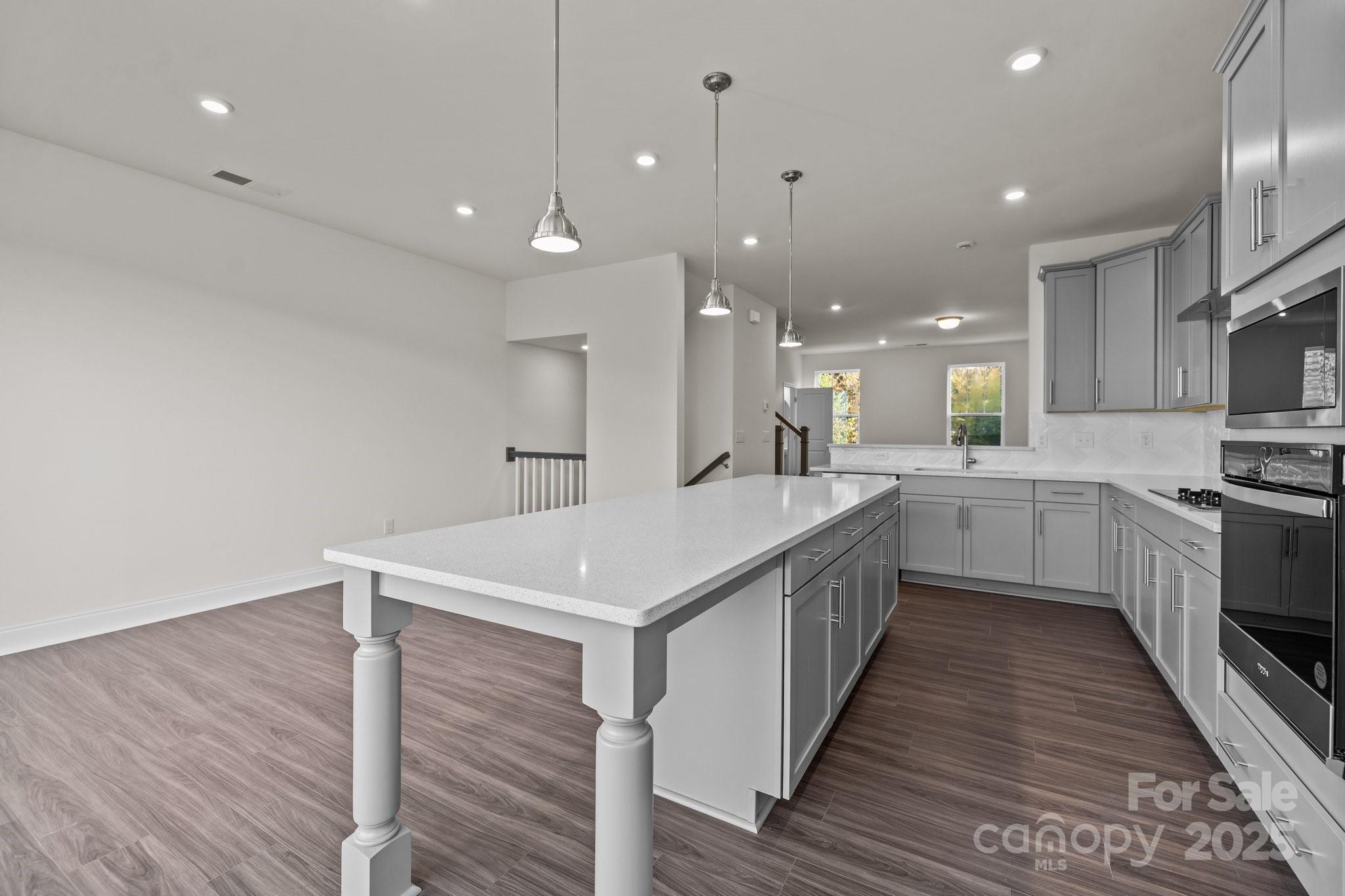 657 District Court Fort Mill, SC 29708 - Photo 14 of 32 a large kitchen with stainless steel appliances a large counter top a sink a refrigerator and a stove