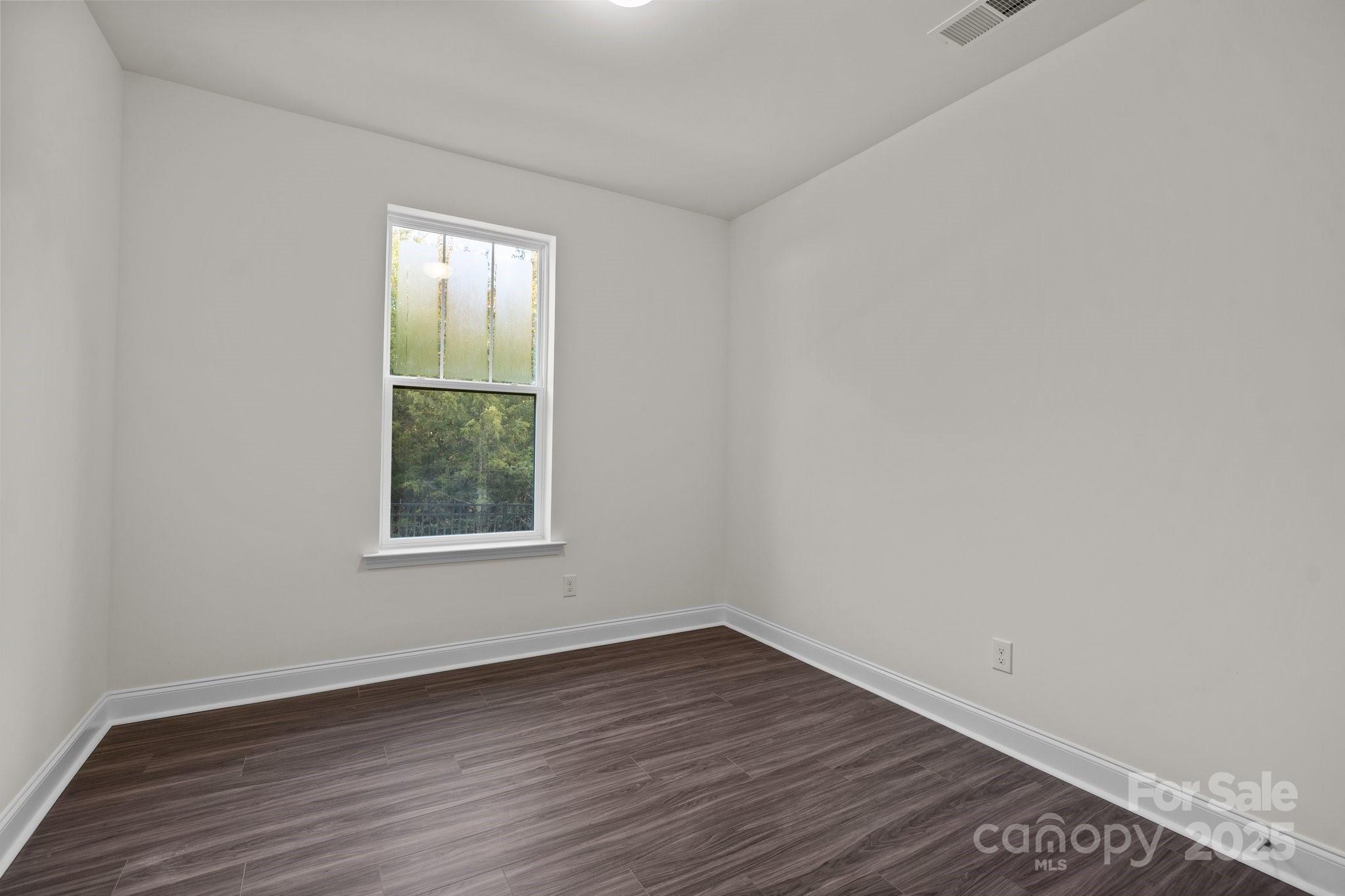 657 District Court Fort Mill, SC 29708 - Photo 8 of 32 an empty room with wooden floor and windows