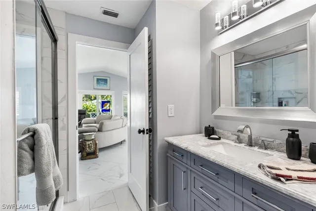 a balcony with chairs and a potted plant