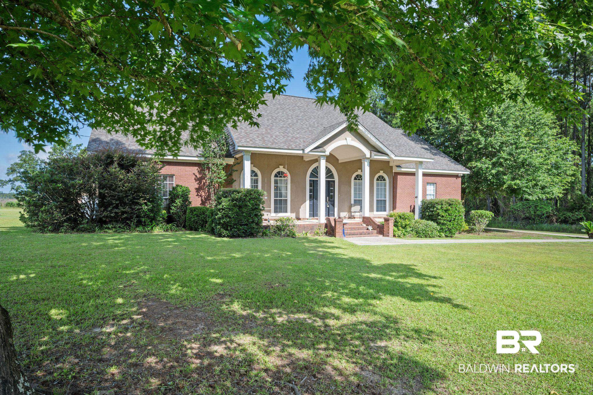 48513 Phillipsville Road Bay Minette, AL 36507 - Photo 3 of 50 View of front facade featuring a front lawn, roof with shingles, brick siding, and a porch