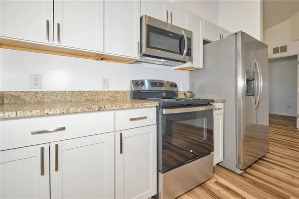 a close view of a sink a counter space and a stove in the kitchen