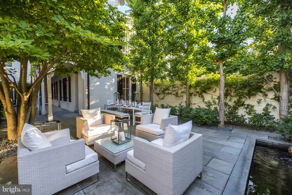 a view of a patio with couches and a fire pit