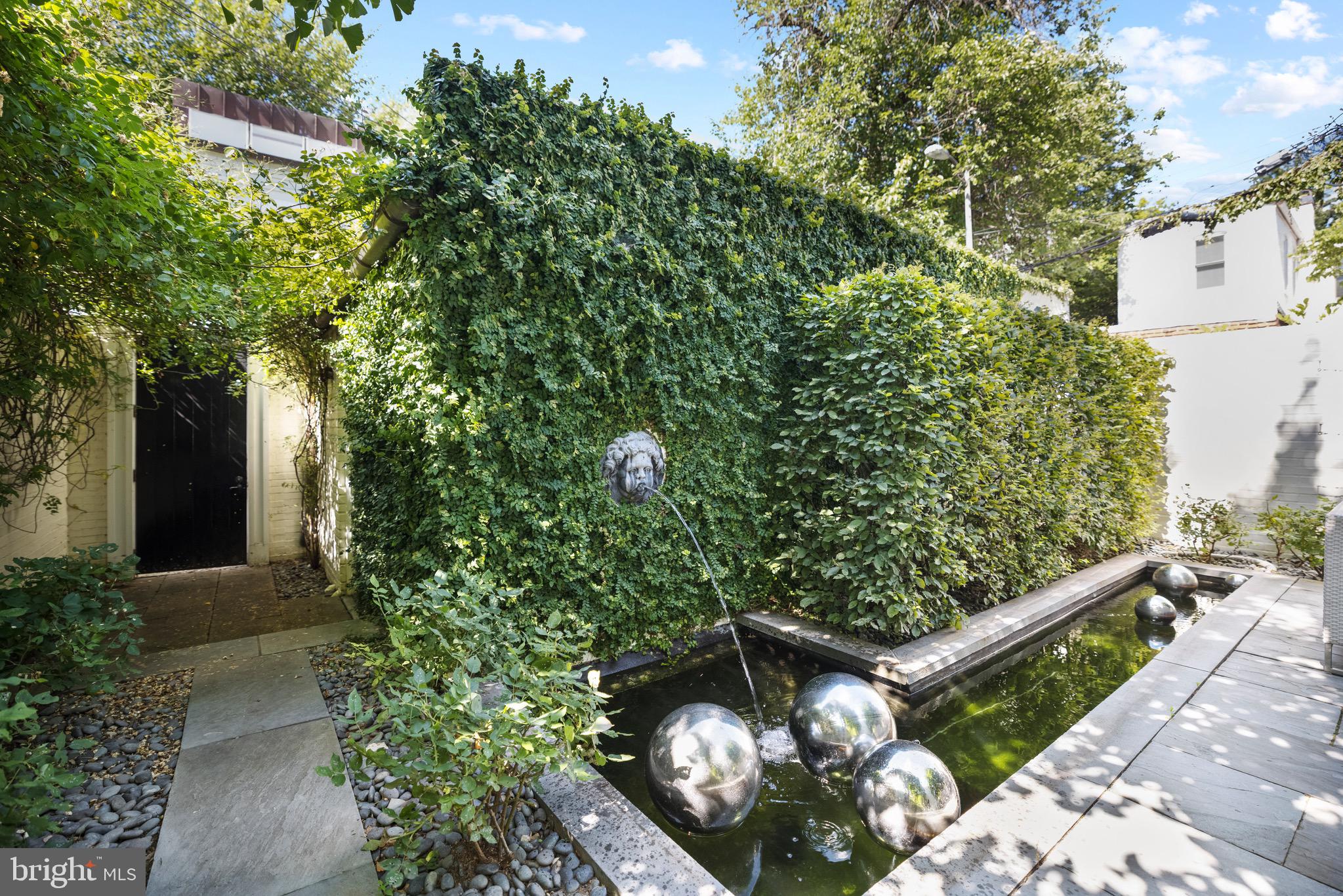 3313 O Street Northwest Washington, DC 20007 - Photo 12 of 31 a view of a wooden house with a flower garden