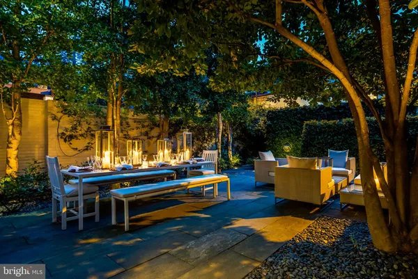 a backyard of a house with table and chairs
