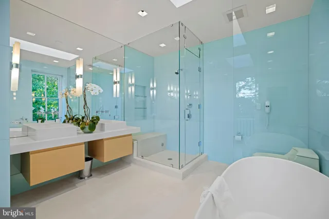 a bathroom with a bathtub shower sink and mirror