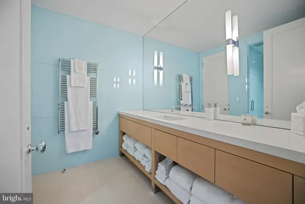 a spacious bathroom with a double vanity sink and a mirror