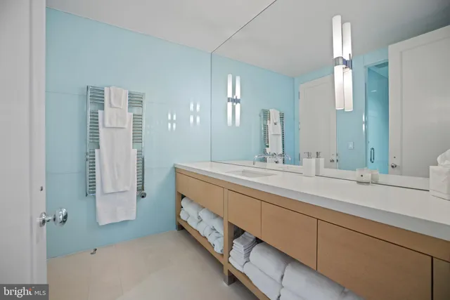 a spacious bathroom with a double vanity sink and a mirror