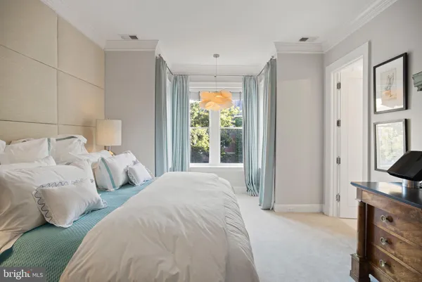 a bedroom with bed and window