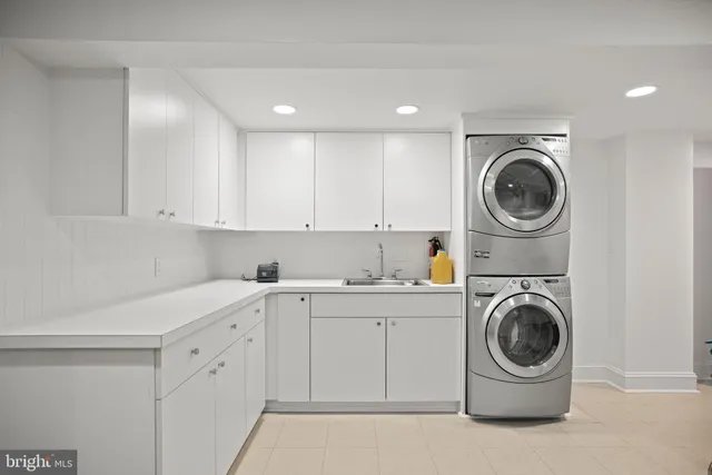 a utility room with sink washer and dryer