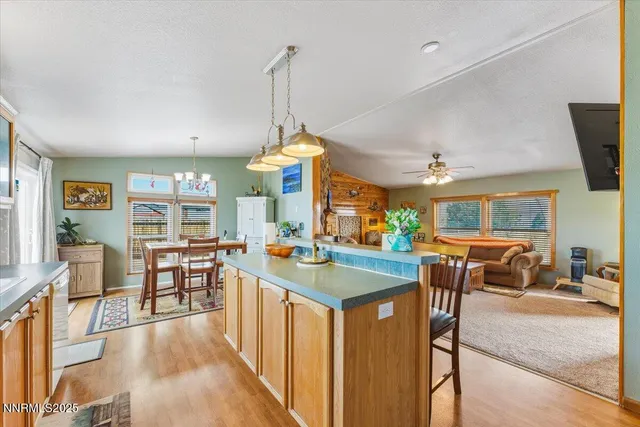 a view of a living room dining room kitchen and windows