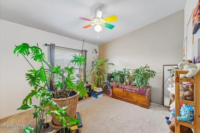 a living room with furniture a chandelier and a window