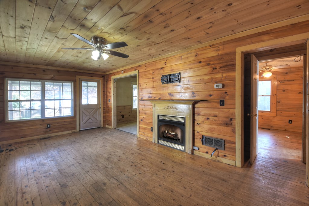 1388 East Main Street Blue Ridge, GA 30513 - Photo 13 of 19 a view of an empty room with a fireplace and a window