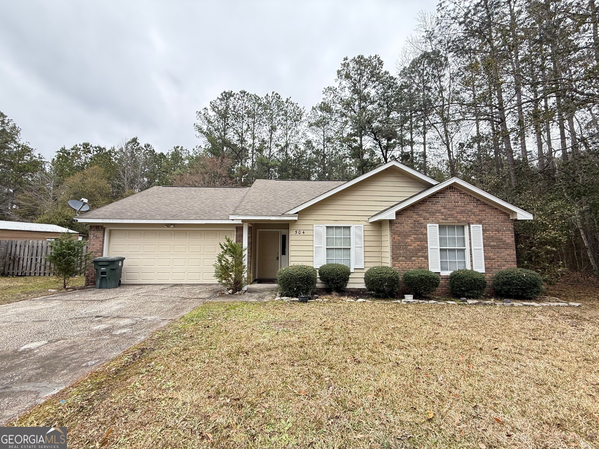 504 Woodbridge Road Kingsland, GA 31548 - Photo 1 of 23 a front view of a house with yard and trees in the background