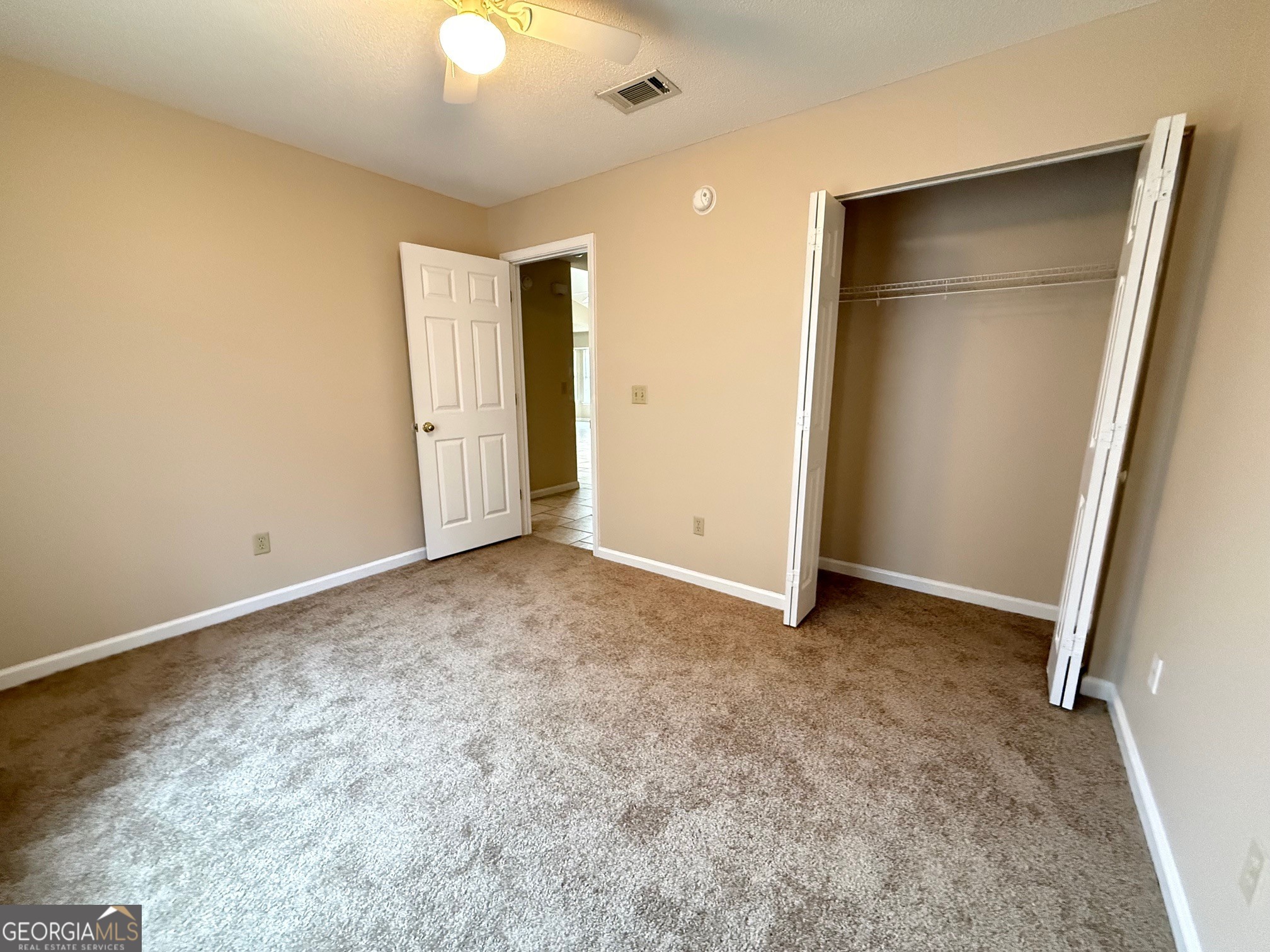 504 Woodbridge Road Kingsland, GA 31548 - Photo 16 of 23 an empty room with closet and a chandelier fan