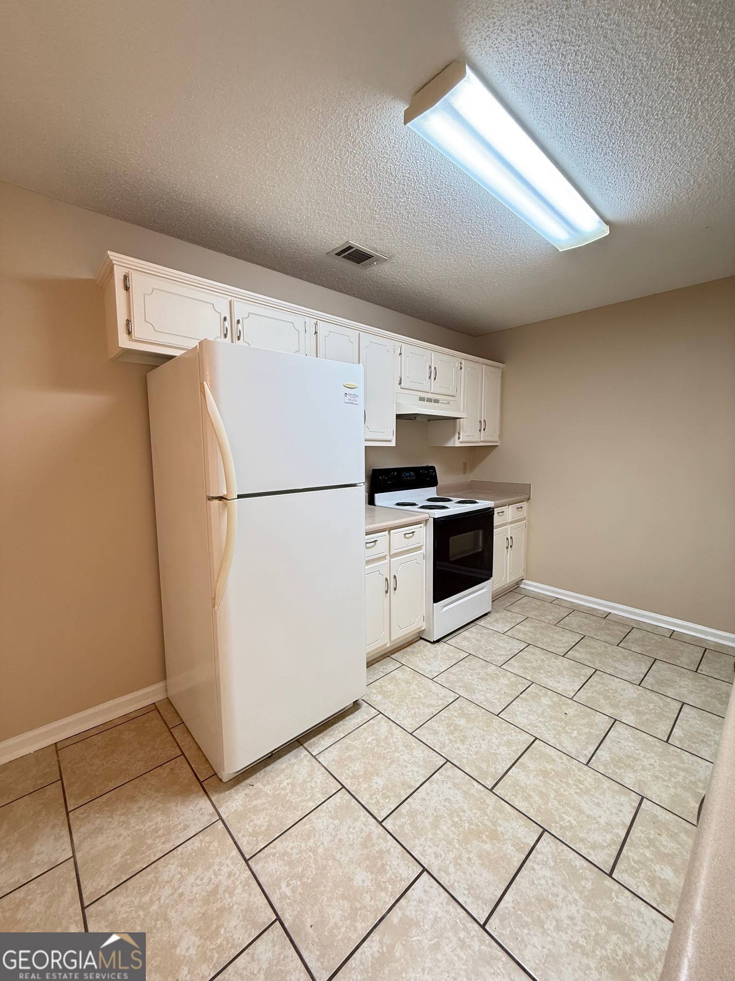 504 Woodbridge Road Kingsland, GA 31548 - Photo 6 of 23 a kitchen with granite countertop a refrigerator and a stove top oven