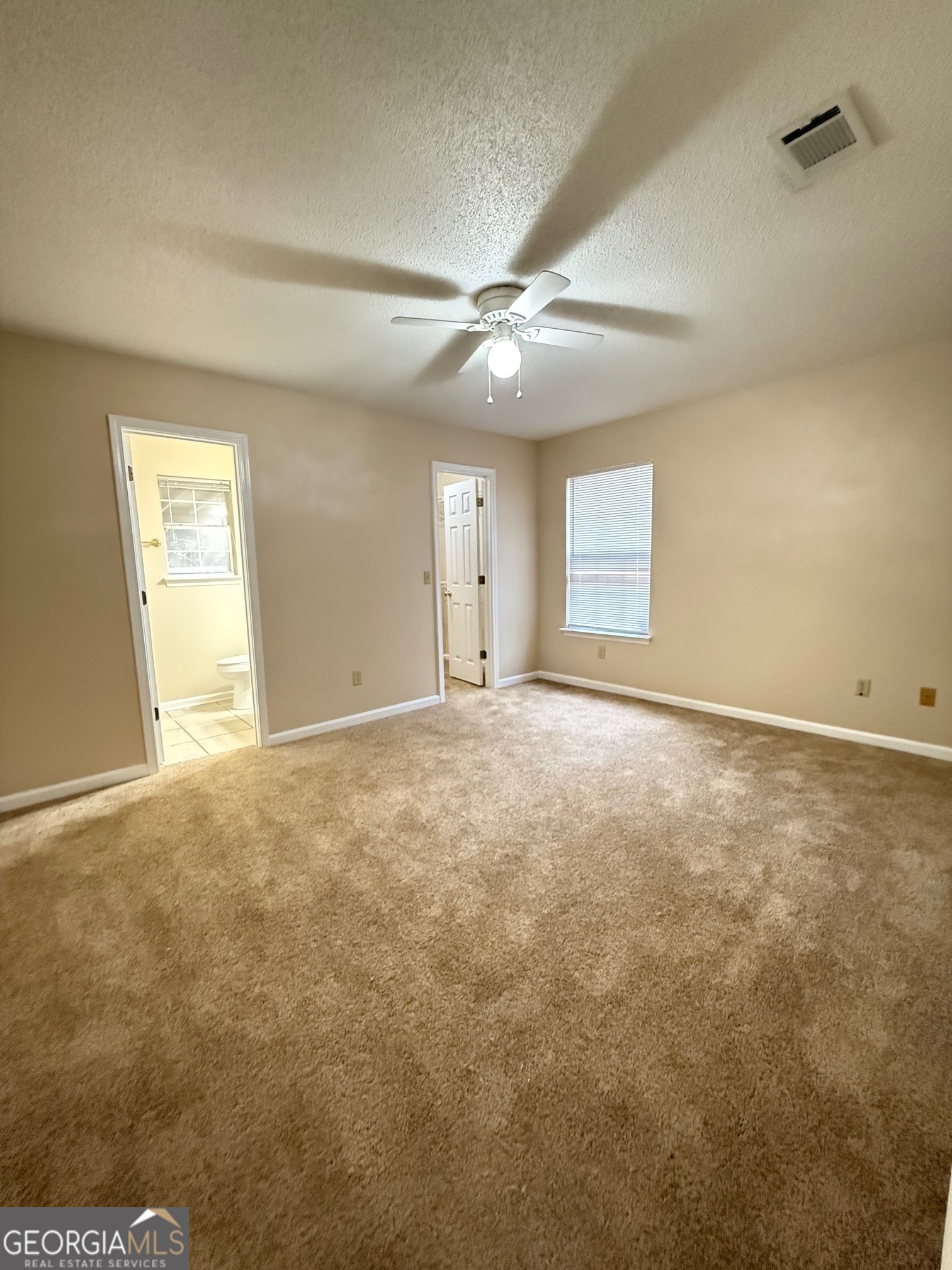 504 Woodbridge Road Kingsland, GA 31548 - Photo 8 of 23 an empty room with an entryway and fan