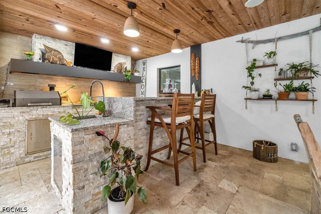 202 Ridgewood Avenue Clewiston, FL 33440 - Photo 27 of 50 a dining room with furniture and a kitchen view
