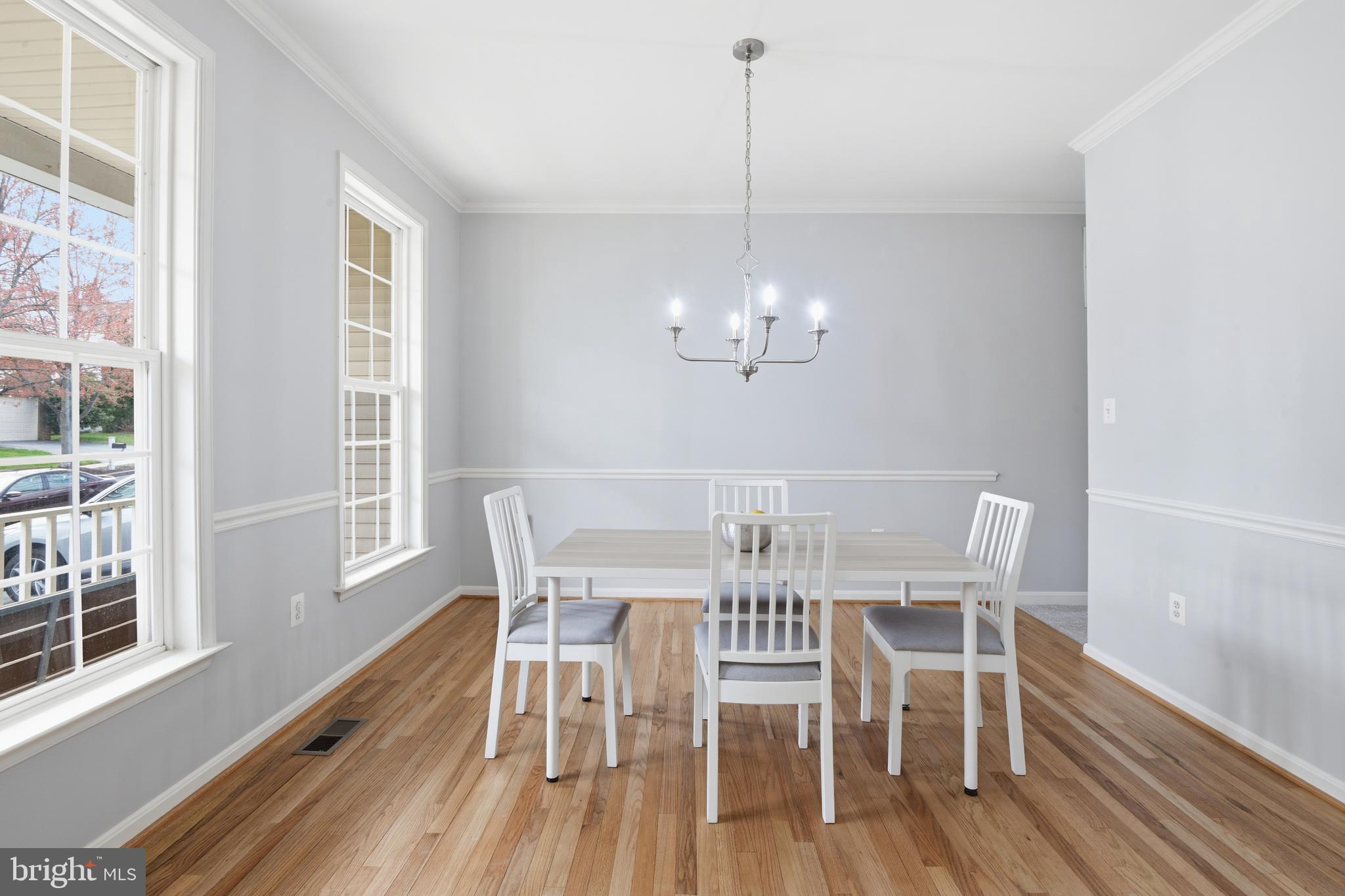 9044 Clendenin Way Frederick, MD 21704 - Photo 12 of 50 a view of a dining room with furniture a chandelier and wooden floor