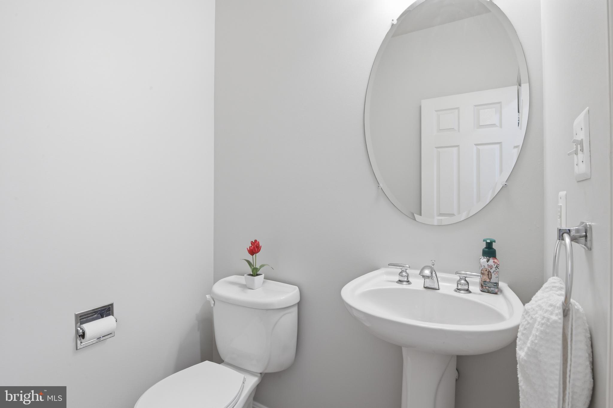 9044 Clendenin Way Frederick, MD 21704 - Photo 16 of 50 a bathroom with a toilet sink and mirror