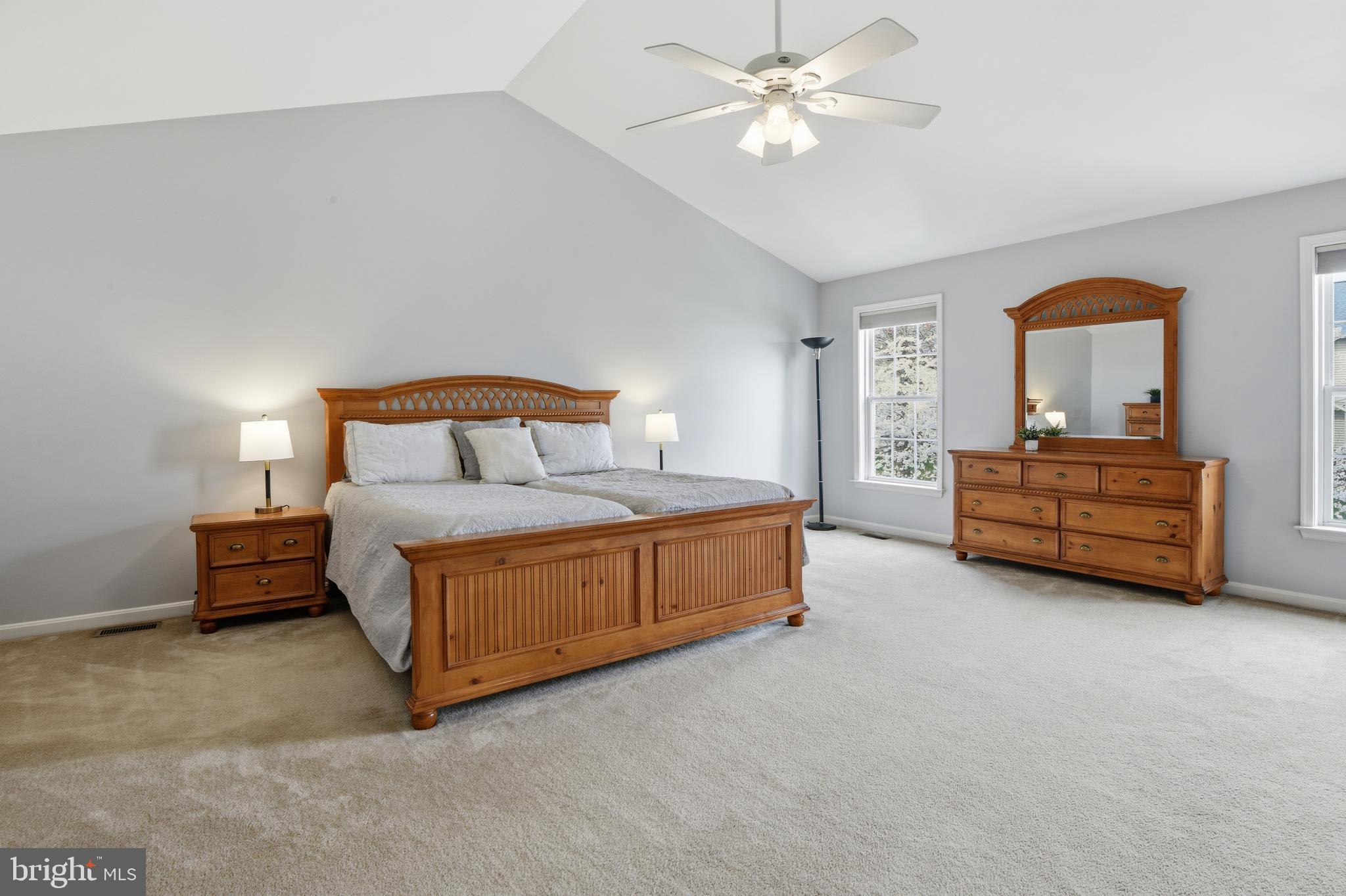 9044 Clendenin Way Frederick, MD 21704 - Photo 17 of 50 a spacious bedroom with a bed and a chandelier