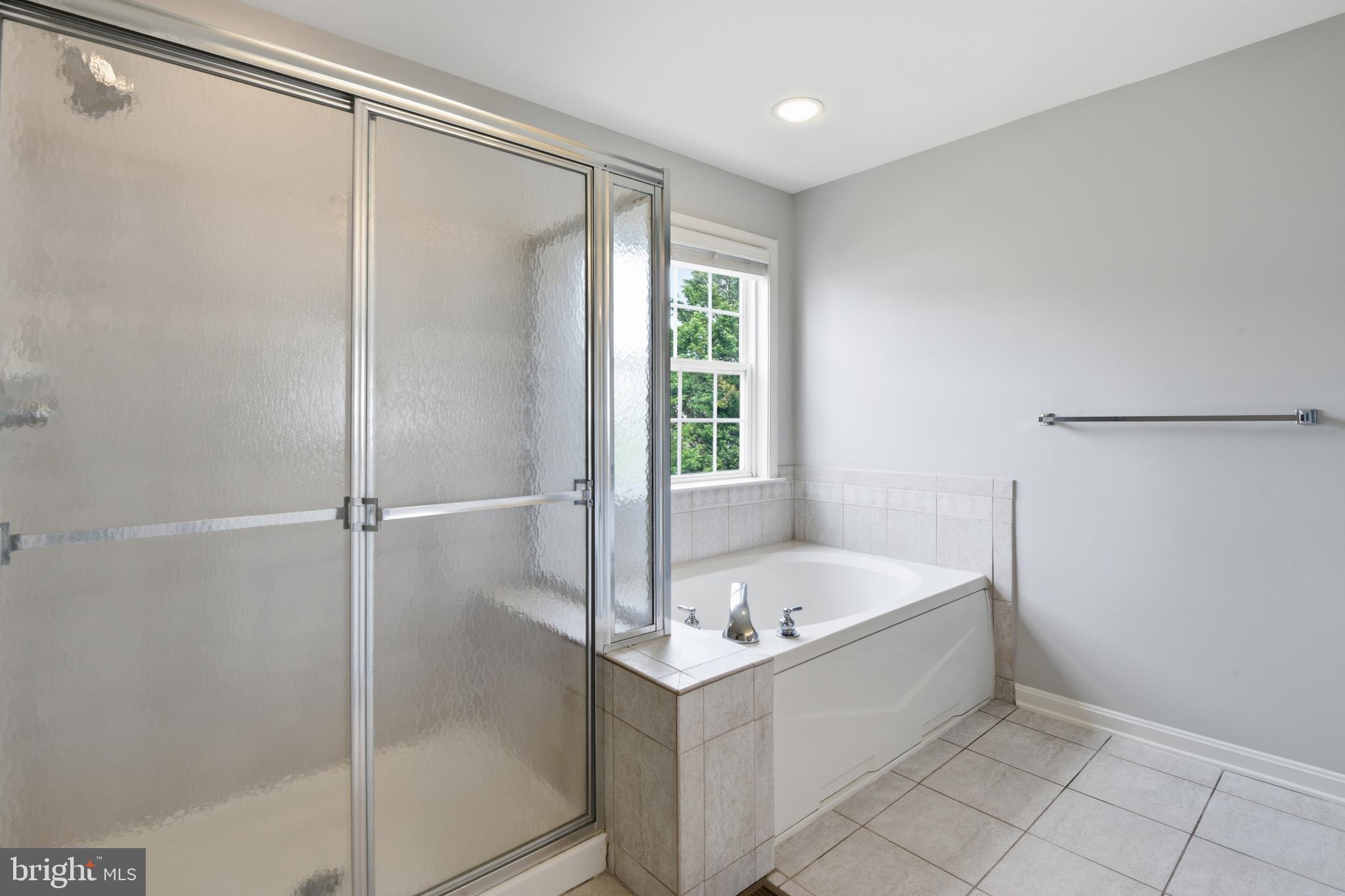9044 Clendenin Way Frederick, MD 21704 - Photo 20 of 50 a bathroom with a bathtub and a shower
