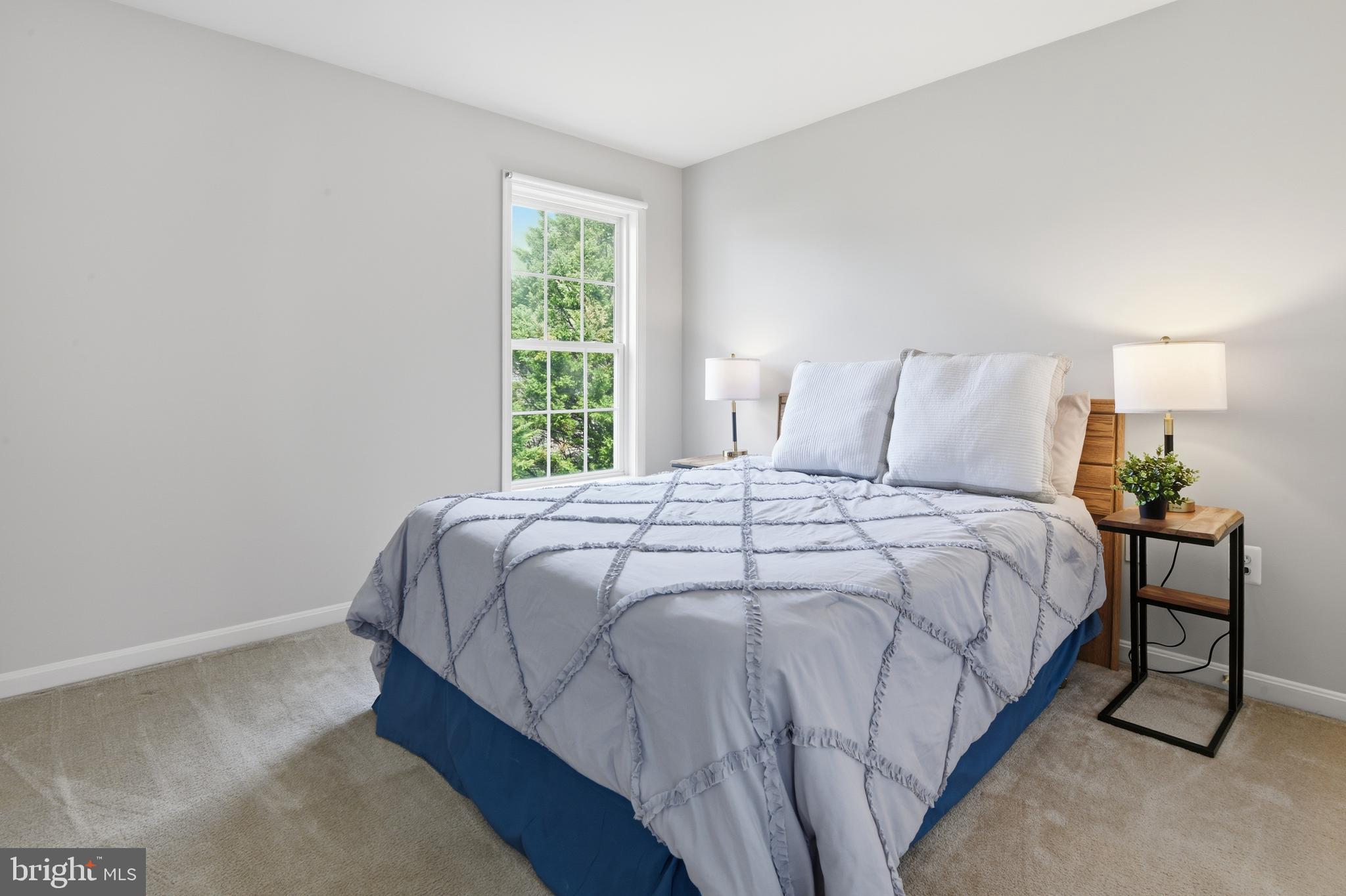 9044 Clendenin Way Frederick, MD 21704 - Photo 22 of 50 a large bed sitting in a bedroom next to a window