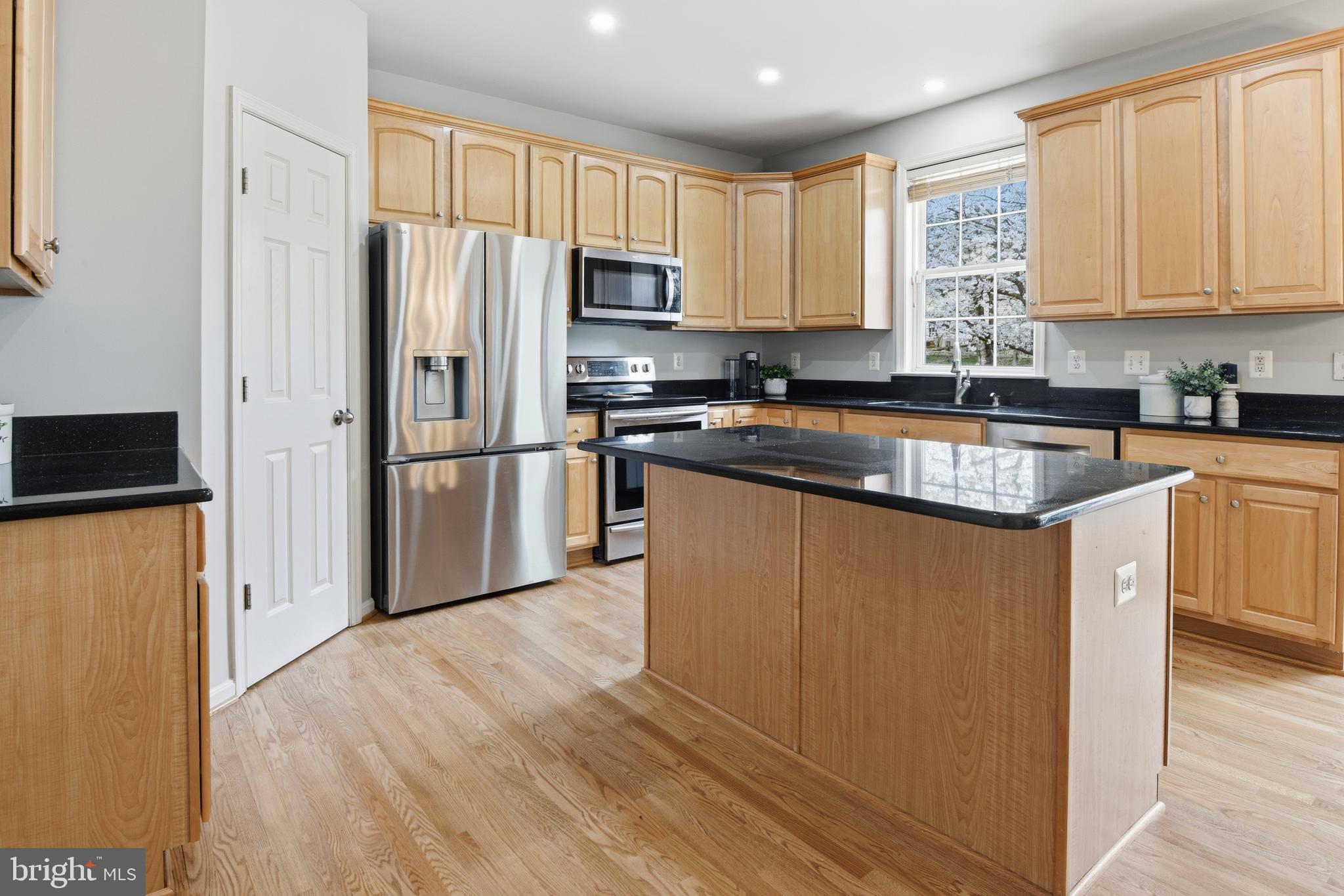 9044 Clendenin Way Frederick, MD 21704 - Photo 5 of 50 a kitchen with stainless steel appliances granite countertop a refrigerator stove and sink