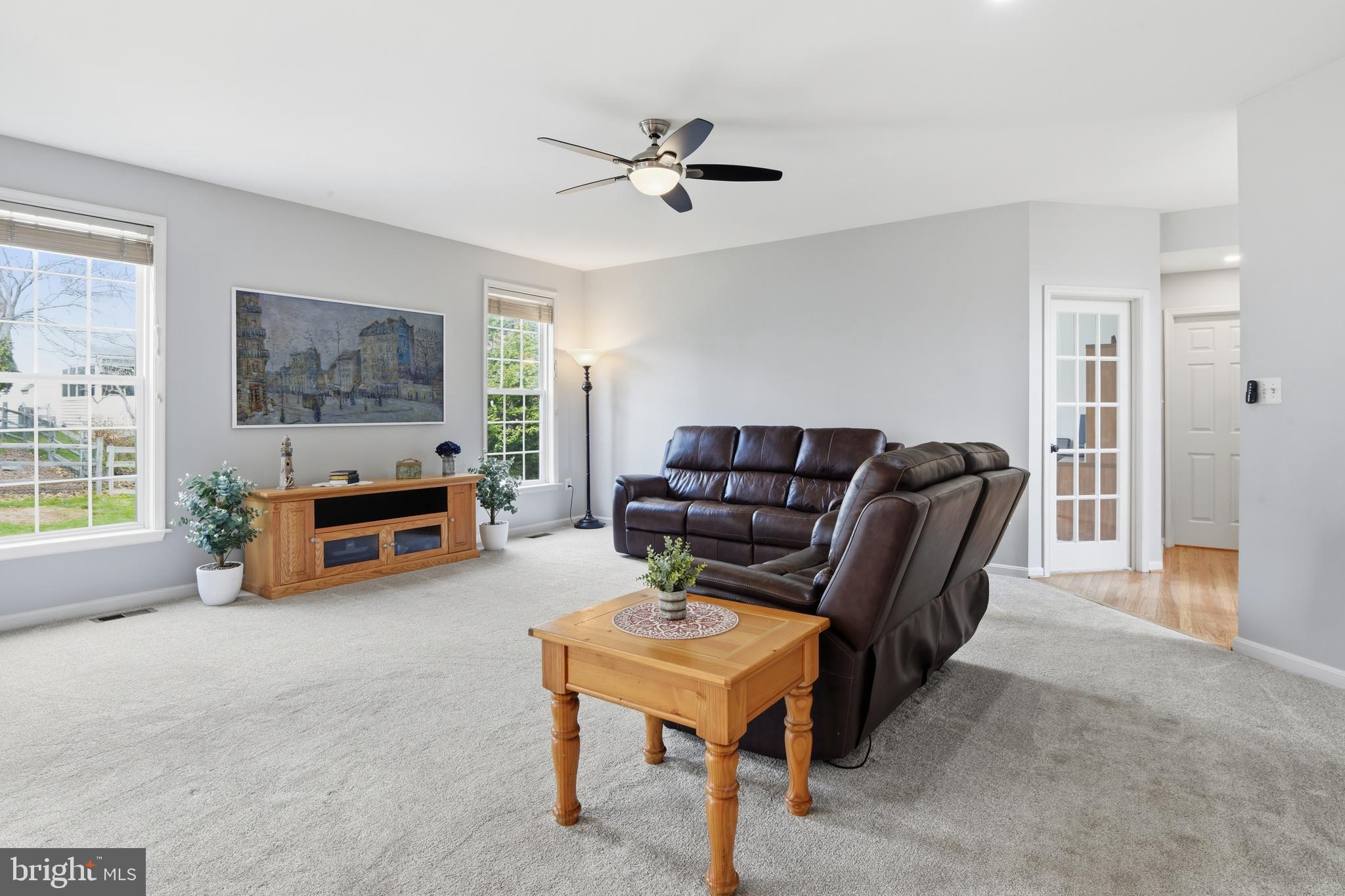 9044 Clendenin Way Frederick, MD 21704 - Photo 9 of 50 a living room with furniture and a flat screen tv