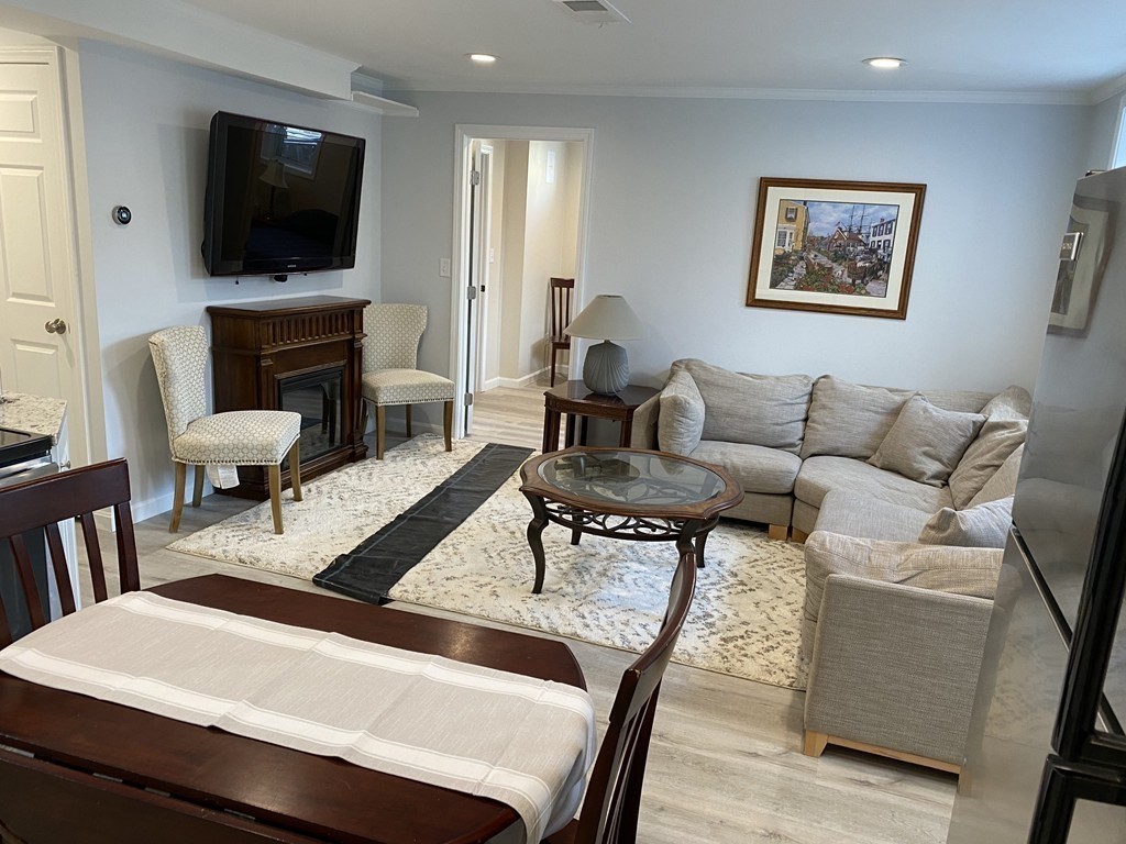 112 Langley Road Newton, MA 02459 - Photo 4 of 14 a living room with furniture and a flat screen tv