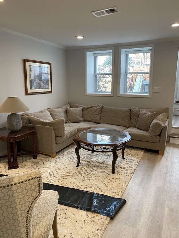 112 Langley Road Newton, MA 02459 - Photo 6 of 14 a living room with furniture a rug and a window
