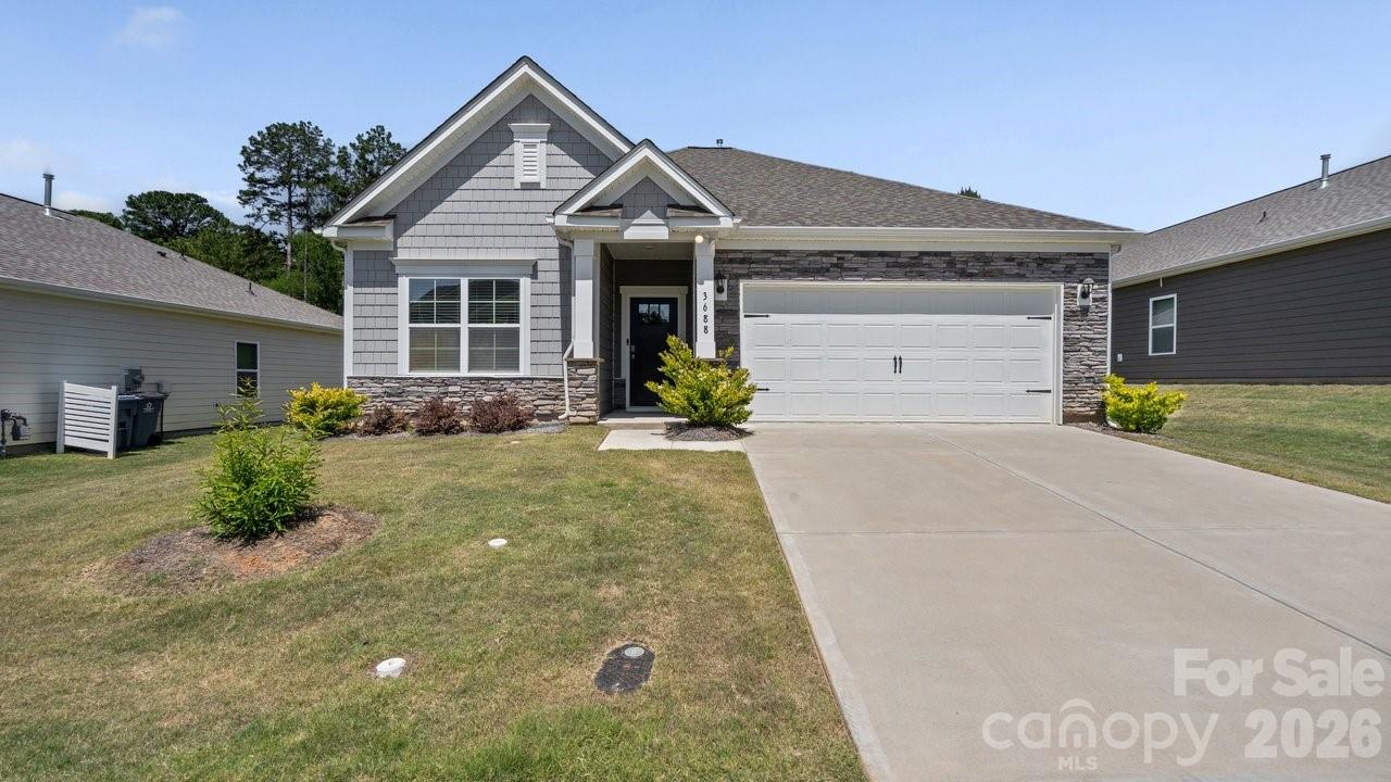 3688 Mercer Street Terrell, NC 28682 - Photo 3 of 34 a front view of a house with a yard and garage