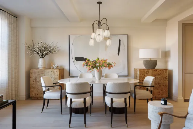 a dining room with furniture a chandelier and wooden floor